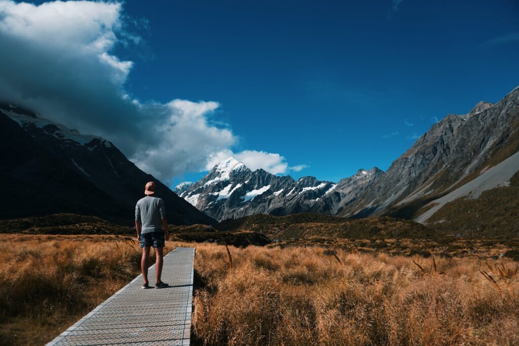 person looking at snow covered mountain